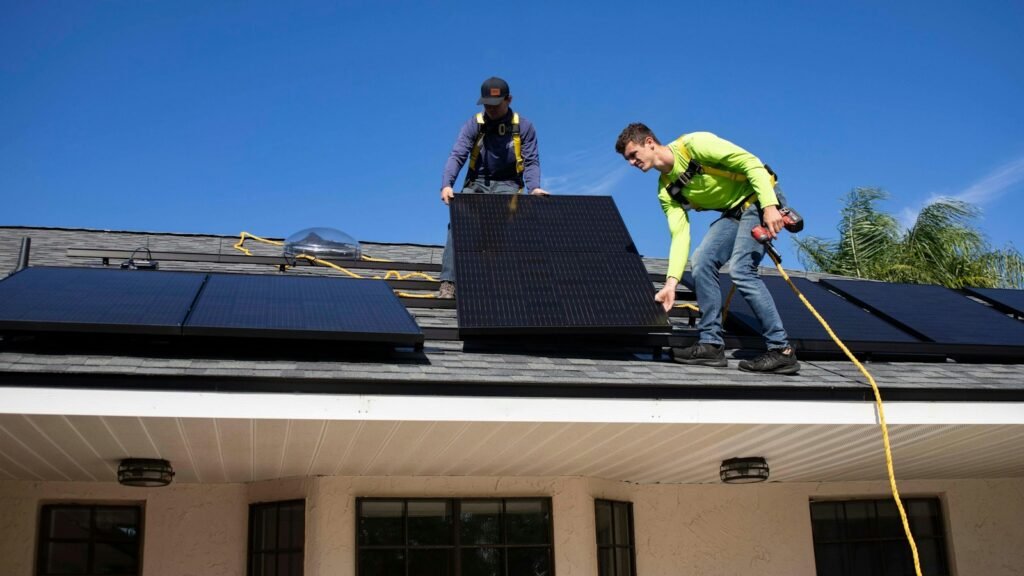 Solar technicians working on rooftop solar panels. Photo by Raze Solar on Unsplash.
